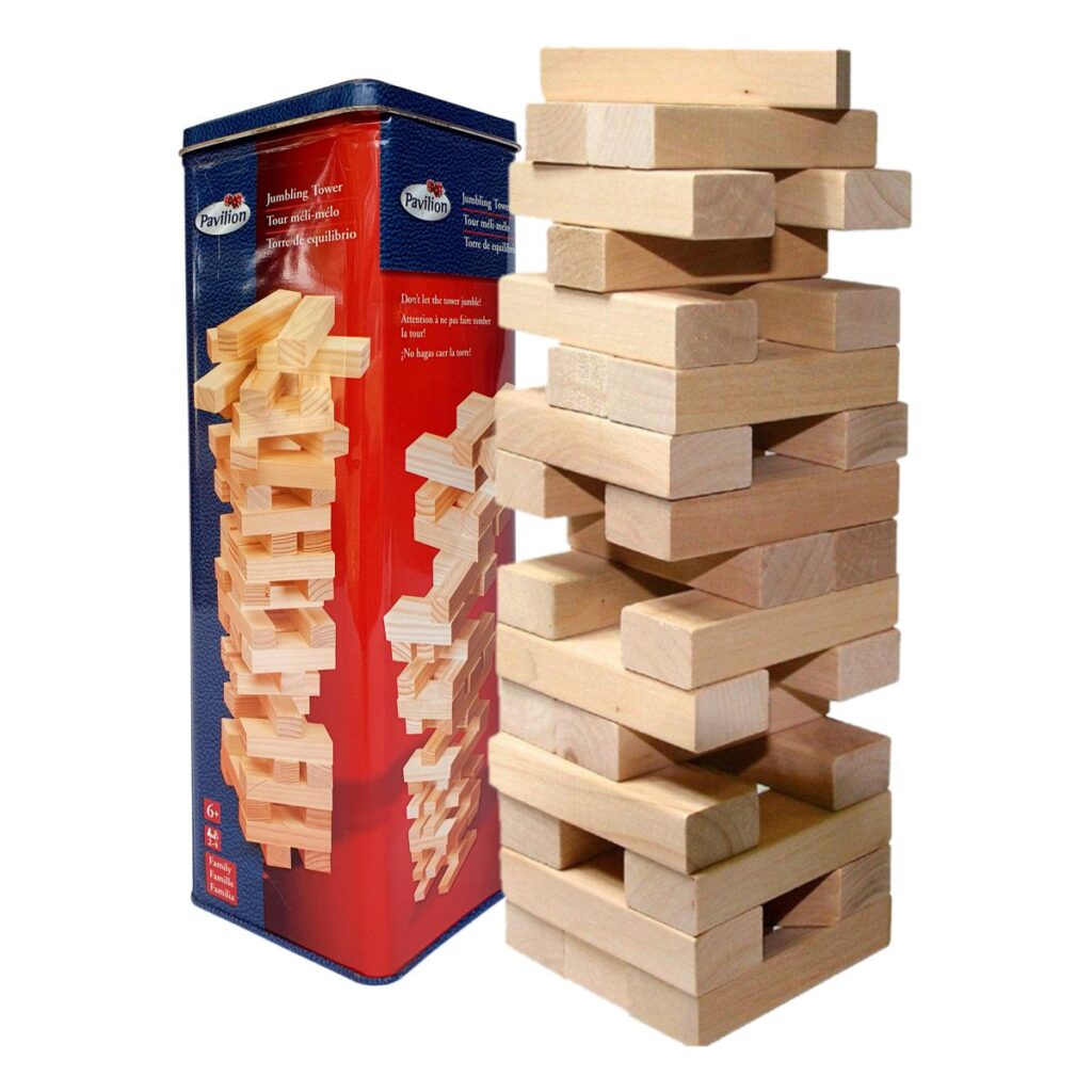 Wooden tumbling tower game blocks stacked beside reusable tin case for family game night.